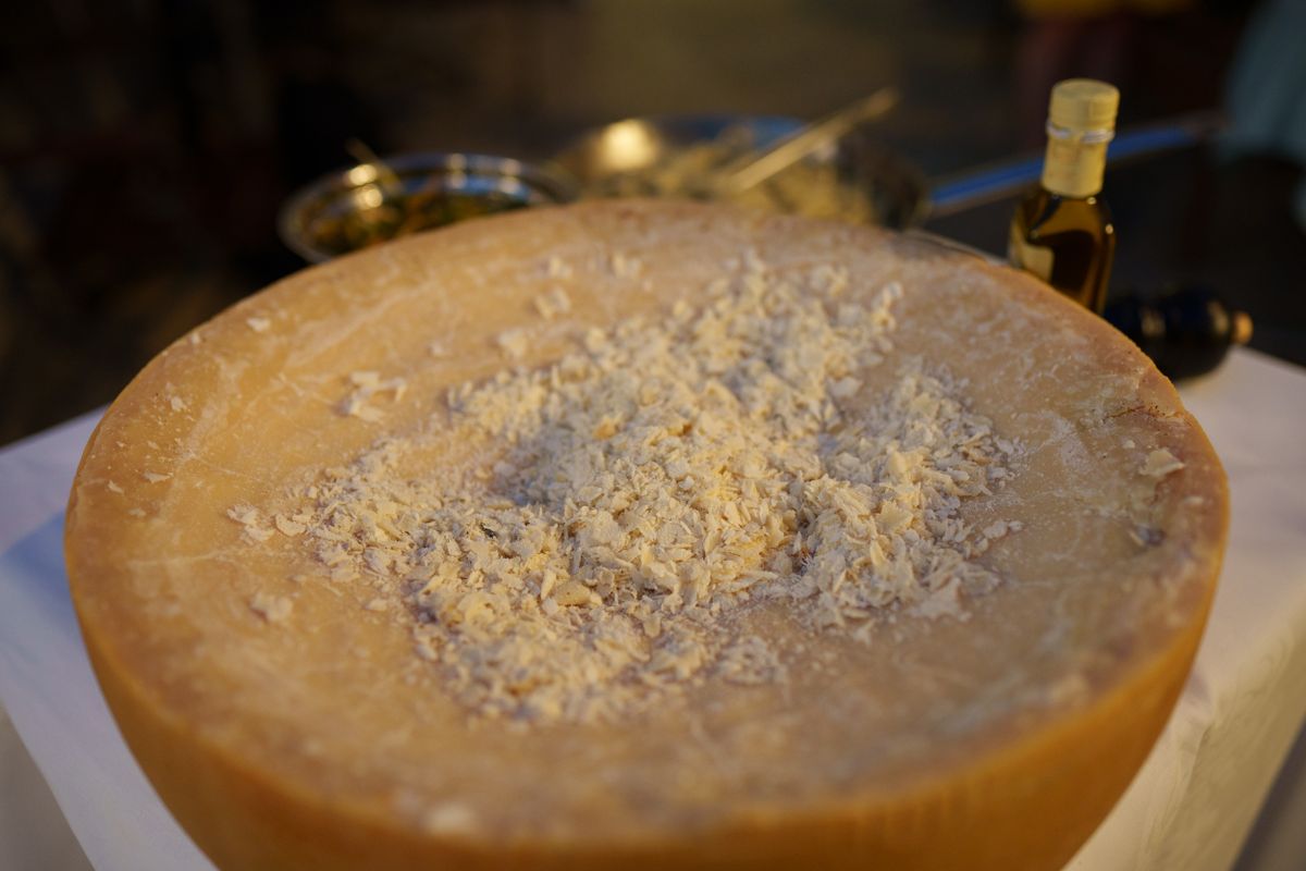 A wheel of Parmigiano Reggiano with fresh shavings
